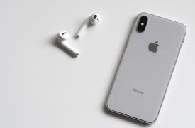An iPhone and a set of ear buds