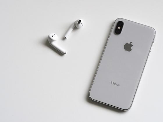 An iPhone and a set of ear buds
