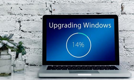 A laptop showing a Windows update at 14 per cent