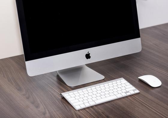 A new iMac on a desk with keyboard and mouse