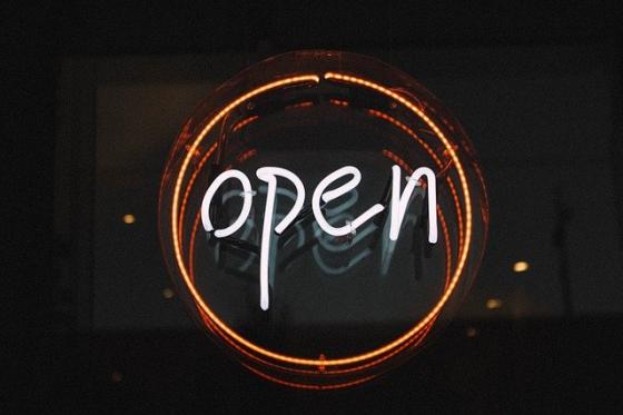 A neon sign saying Open