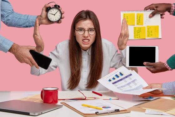 Woman employee frustrated by lots of different tasks being thrown at her