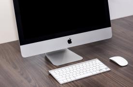 A new iMac on a desk with keyboard and mouse