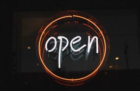 A neon sign saying Open